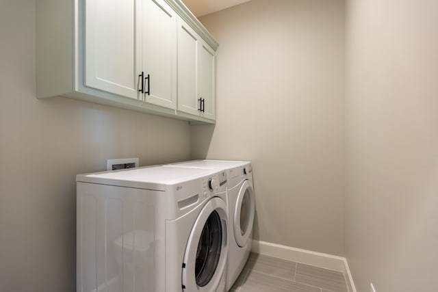 5039 Hatfield Cir, Hahira, GA 31632 - laundry area with cabinet space, washer and clothes dryer, and baseboards
