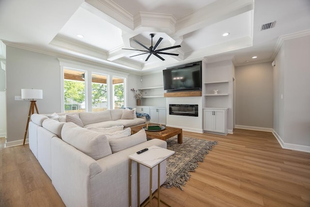 5039 Hatfield Cir, Hahira, GA 31632 - living room featuring ornamental molding, coffered ceiling, light wood-style floors, baseboards, and a glass covered fireplace