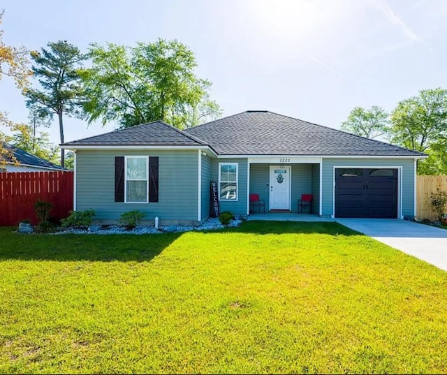 ranch-style house featuring a garage and a front lawn