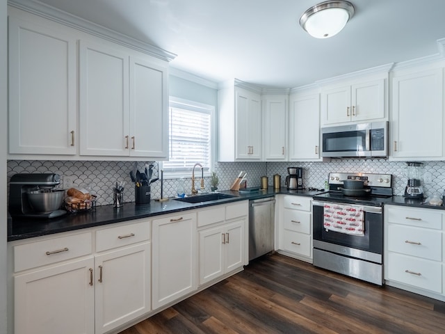 kitchen featuring dark wood-type flooring, stainless steel appliances, sink, and white cabinets