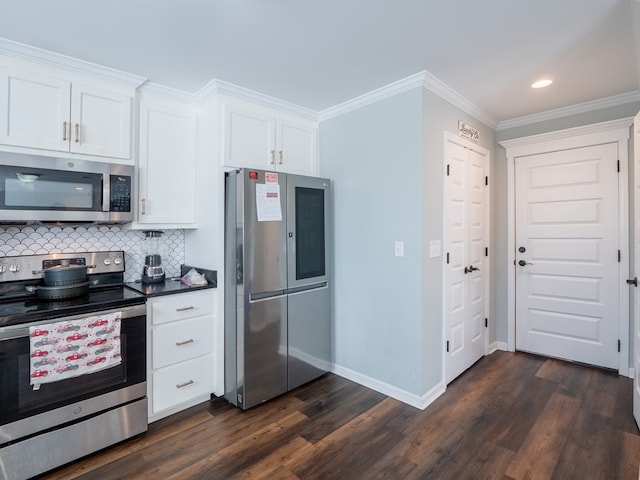 kitchen featuring appliances with stainless steel finishes, white cabinetry, decorative backsplash, crown molding, and dark wood-type flooring