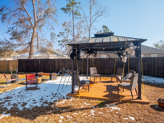 yard covered in snow with a gazebo and a deck