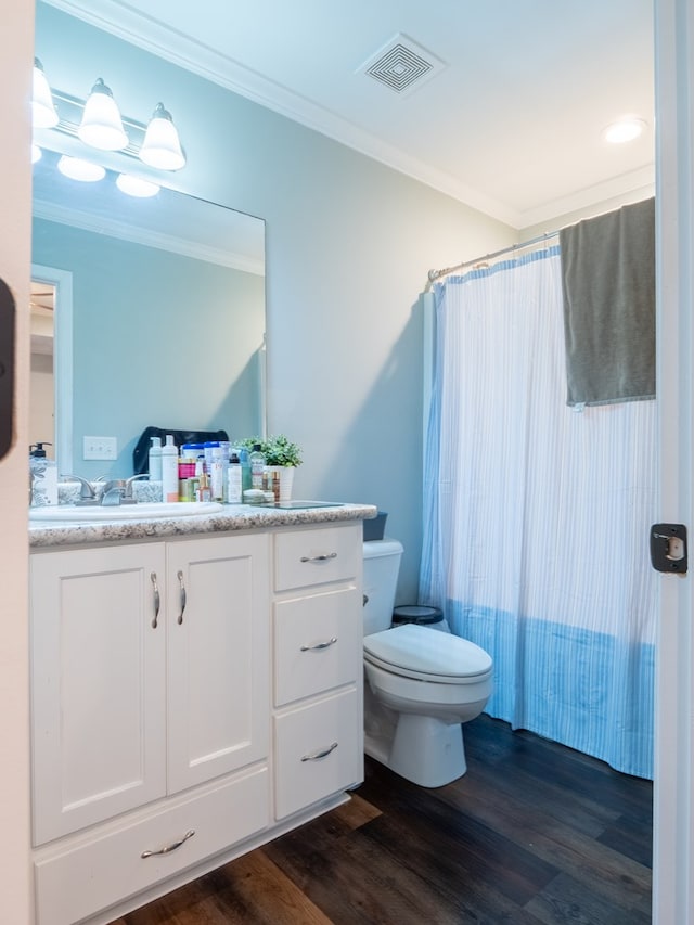 full bathroom featuring ornamental molding, hardwood / wood-style floors, and vanity