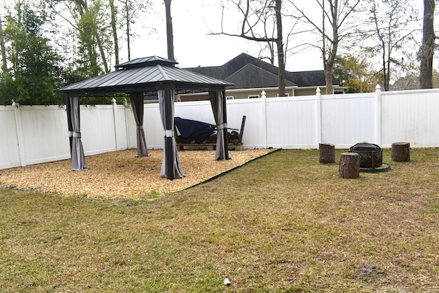 view of yard featuring a gazebo and a fire pit