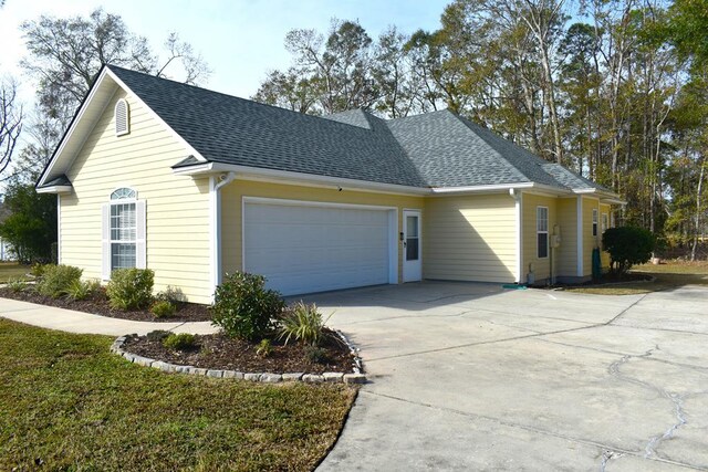 view of side of home featuring a garage