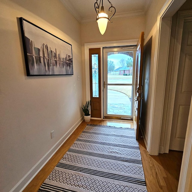 entryway featuring crown molding and light wood-type flooring