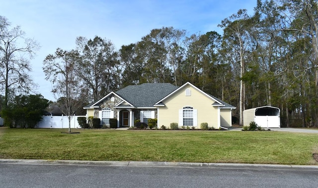 single story home with a front yard and a carport