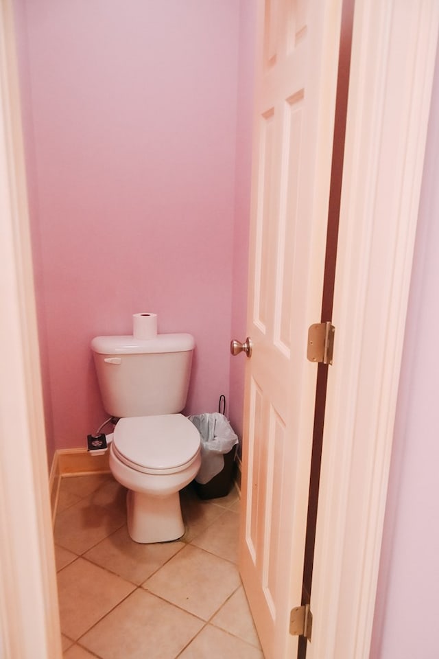 bathroom with toilet and tile patterned flooring