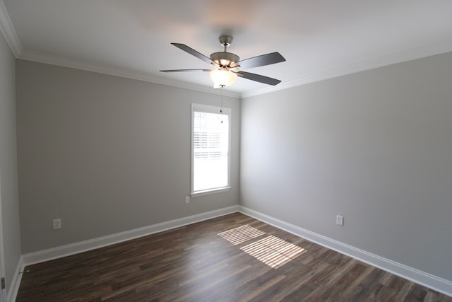 spare room with dark wood finished floors, baseboards, crown molding, and a ceiling fan