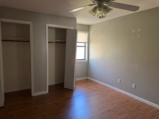 11 Crestwood Cir, Valdosta, GA 31602 - unfurnished bedroom with multiple closets, wood finished floors, baseboards, and ceiling fan