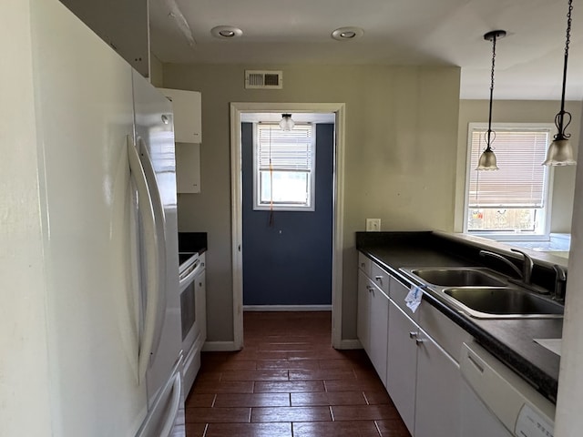 11 Crestwood Cir, Valdosta, GA 31602 - kitchen with white appliances, a sink, dark countertops, and healthy amount of natural light