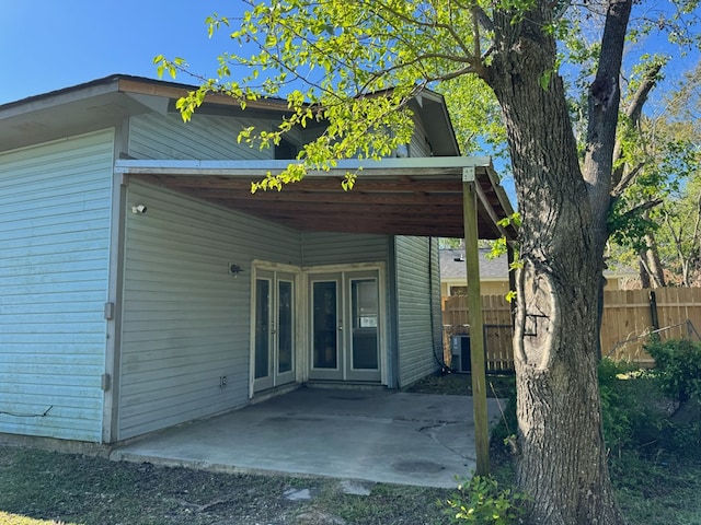 11 Crestwood Cir, Valdosta, GA 31602 - rear view of house featuring french doors, fence, a patio, and an attached carport