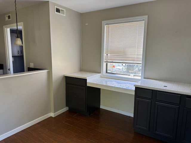 11 Crestwood Cir, Valdosta, GA 31602 - unfurnished office with built in desk, dark wood-style floors, and baseboards