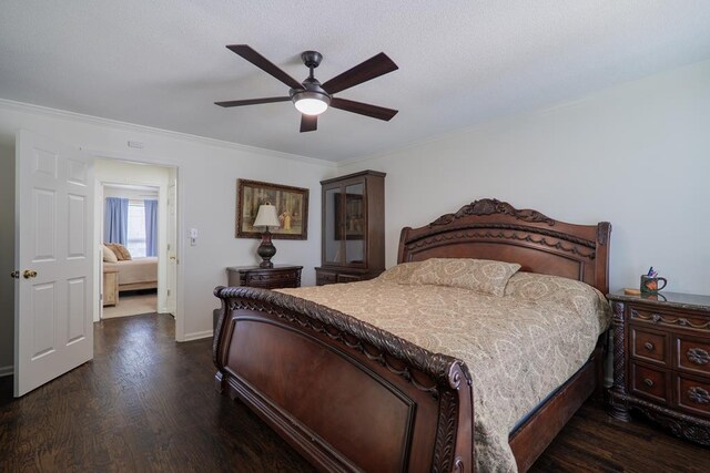 bedroom featuring ceiling fan, dark hardwood / wood-style floors, and ornamental molding