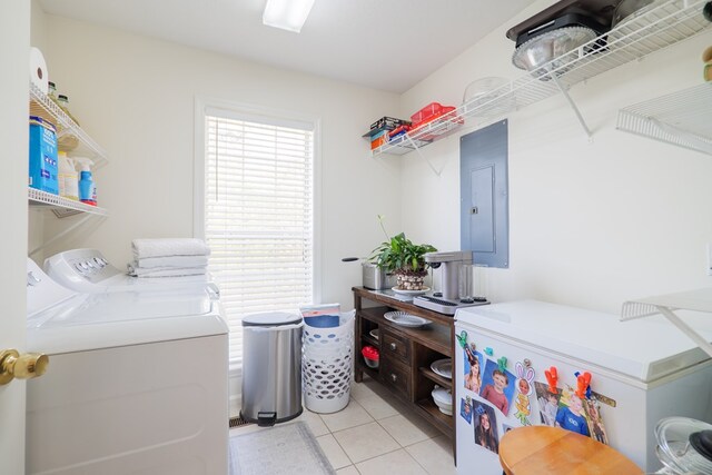 laundry area with light tile patterned floors, electric panel, and separate washer and dryer