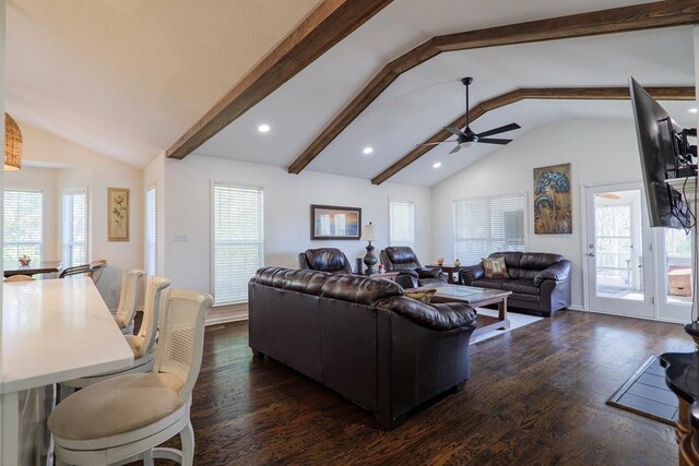 living room featuring vaulted ceiling with beams and a healthy amount of sunlight