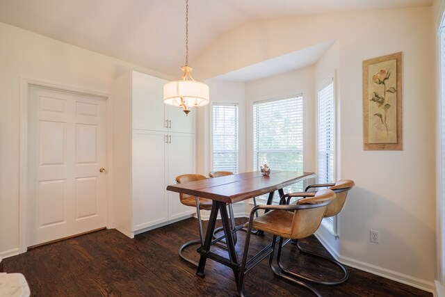 dining space with dark hardwood / wood-style flooring and lofted ceiling