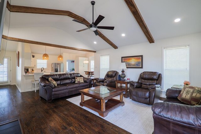 living room featuring beamed ceiling, dark hardwood / wood-style floors, ceiling fan, and high vaulted ceiling