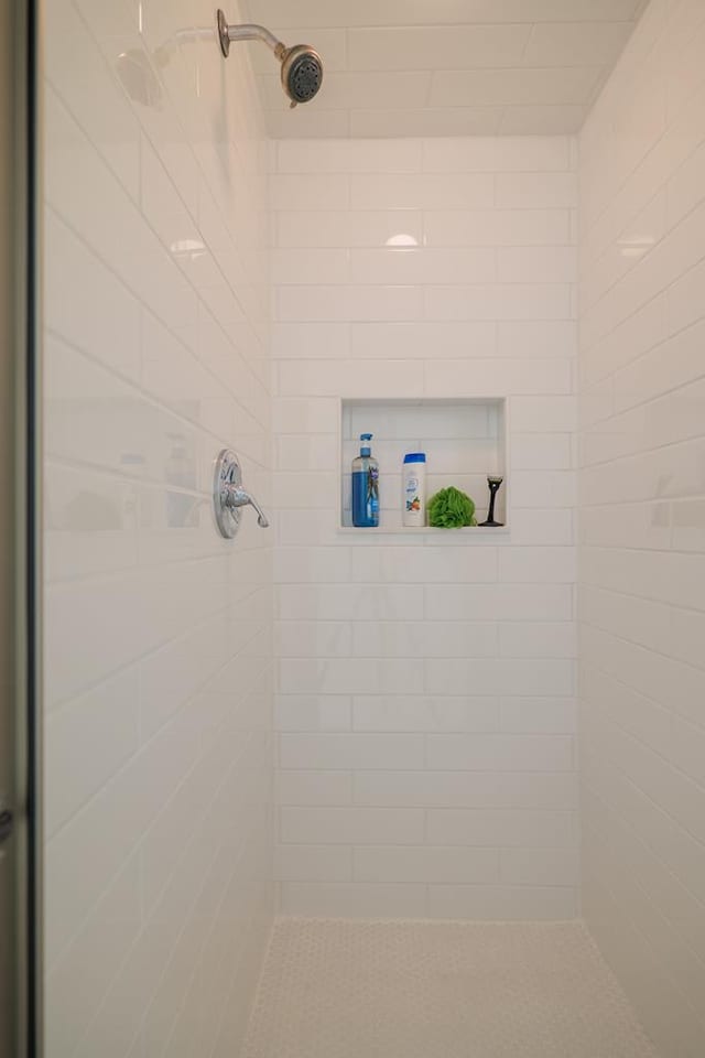 bathroom with tiled shower