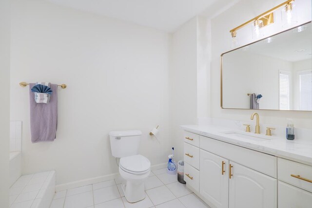 bathroom with tile patterned flooring, vanity, and toilet