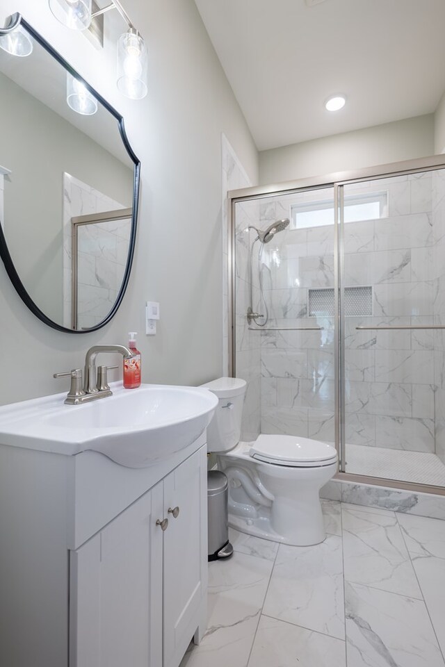 bathroom with vanity, an enclosed shower, and toilet