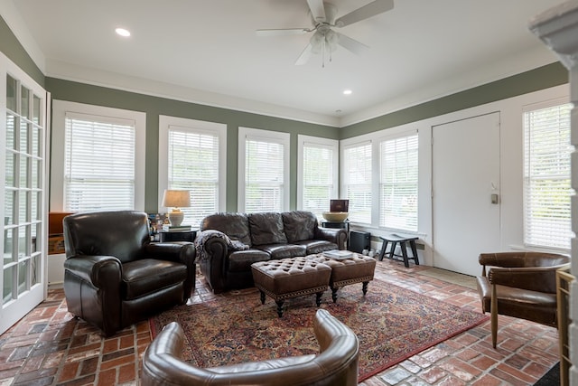 living room with ceiling fan and ornamental molding