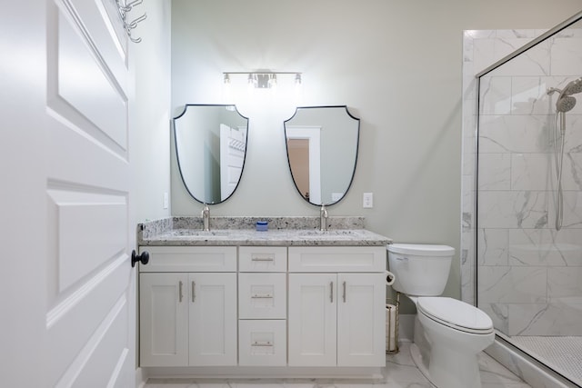 bathroom featuring vanity, toilet, and a shower with shower door