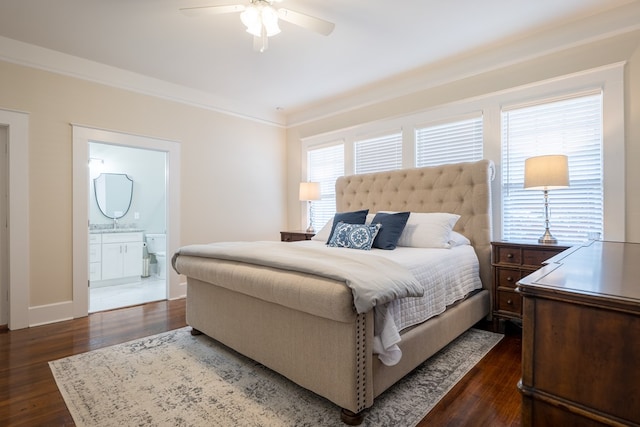 bedroom featuring connected bathroom, multiple windows, and dark hardwood / wood-style floors