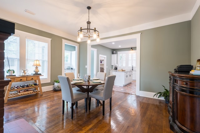 dining area featuring a chandelier, dark hardwood / wood-style flooring, and plenty of natural light