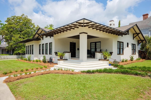 rear view of property with a yard