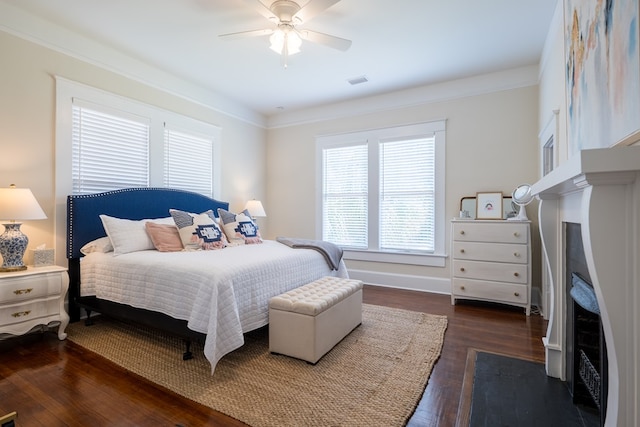 bedroom with crown molding, ceiling fan, and dark wood-type flooring