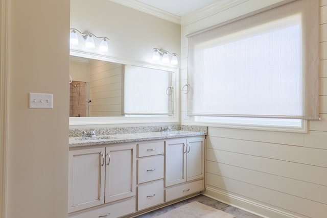 bathroom with vanity, ornamental molding, and a shower