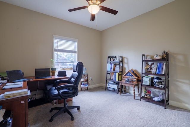 home office with ceiling fan and light carpet