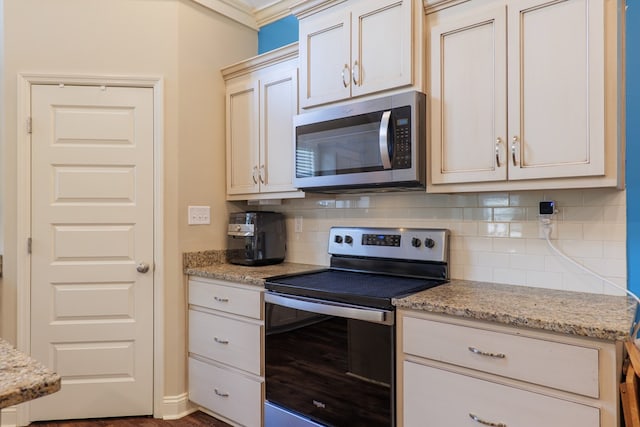 kitchen with light stone counters, tasteful backsplash, and stainless steel appliances