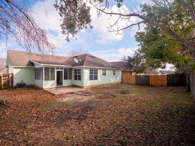 back of property with a sunroom, cooling unit, and a patio area