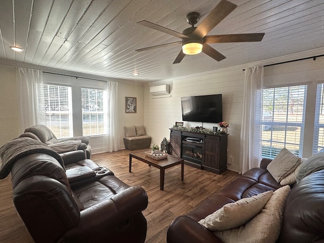 living room featuring crown molding, wood ceiling, wood-type flooring, and a healthy amount of sunlight