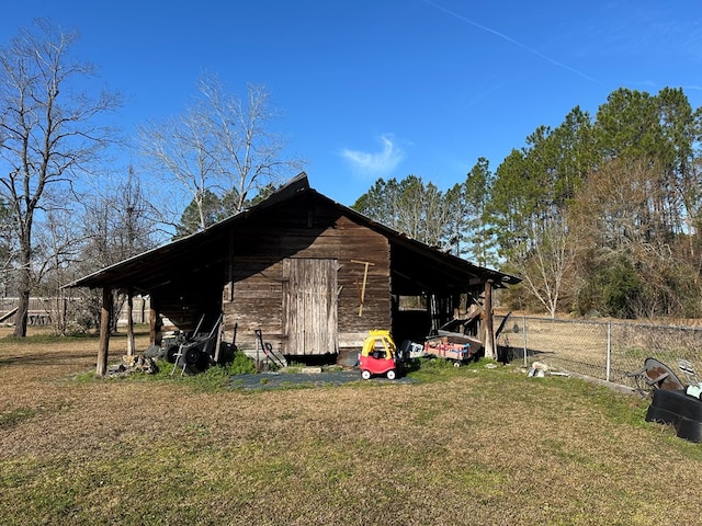 view of outdoor structure featuring a lawn