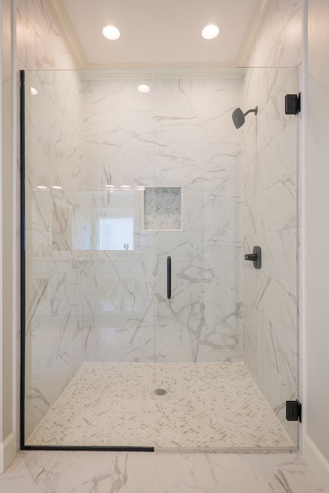 bathroom featuring ornamental molding and walk in shower