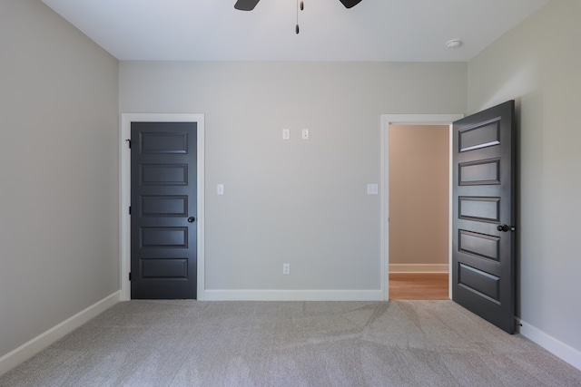 carpeted spare room with ceiling fan