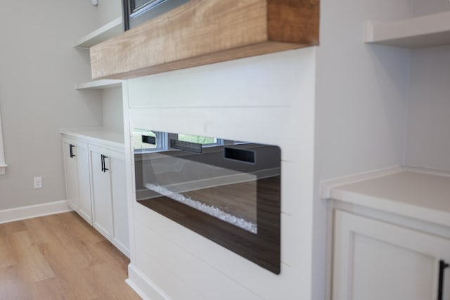 kitchen featuring white cabinetry and light hardwood / wood-style floors