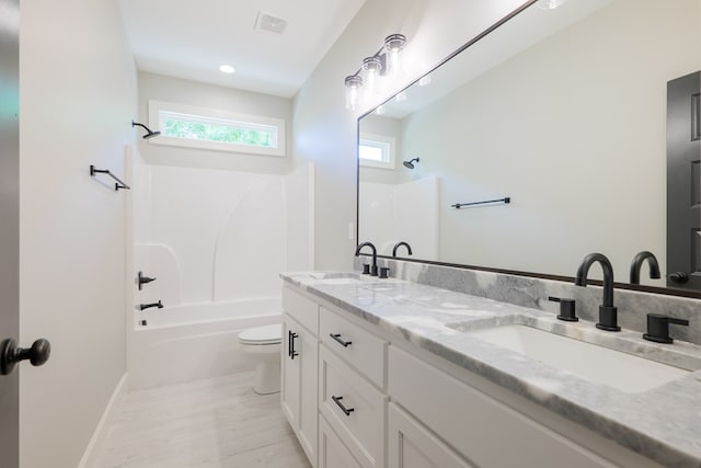 full bathroom with shower / washtub combination, a wealth of natural light, vanity, and toilet