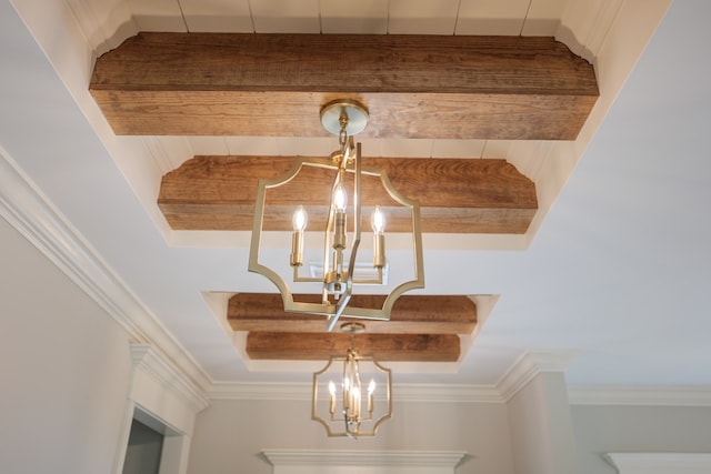 details with a raised ceiling, crown molding, and a notable chandelier