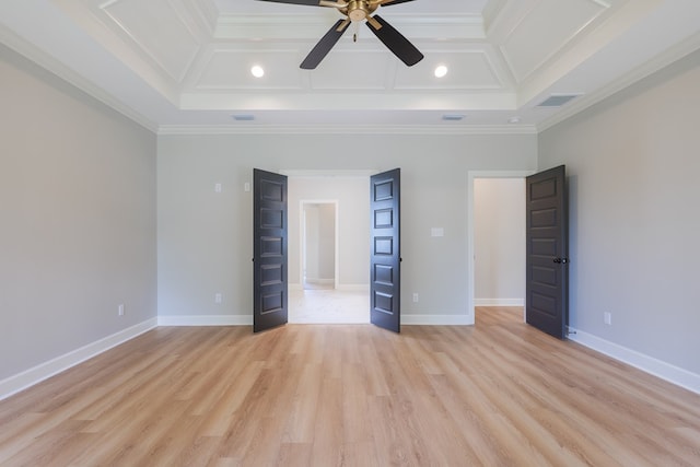 unfurnished bedroom with crown molding, a towering ceiling, coffered ceiling, and light hardwood / wood-style flooring