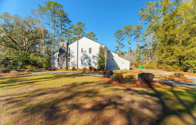 view of side of property with a lawn