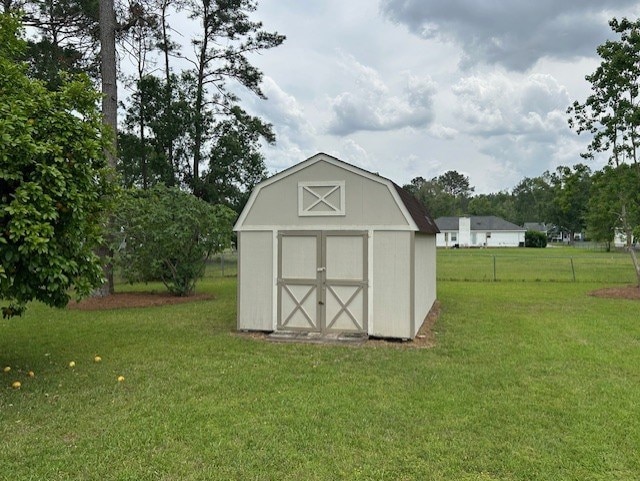 view of shed with fence