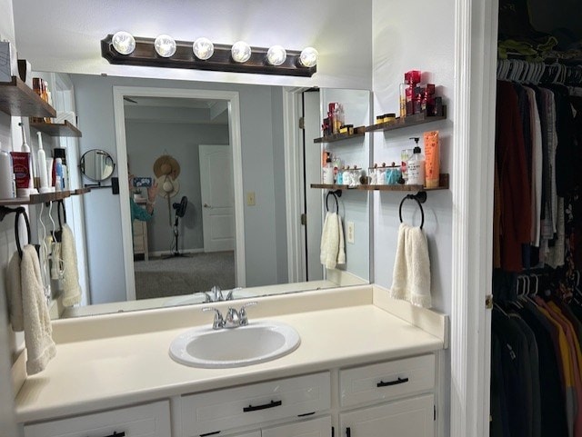 bathroom with a spacious closet and vanity
