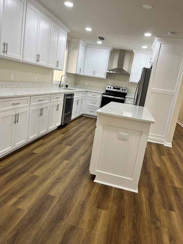 kitchen featuring wall chimney exhaust hood, dark hardwood / wood-style floors, light stone countertops, appliances with stainless steel finishes, and white cabinetry