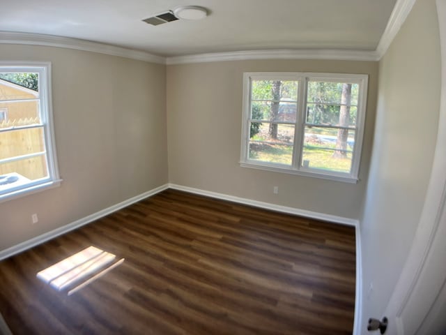 unfurnished room with ornamental molding and dark wood-type flooring