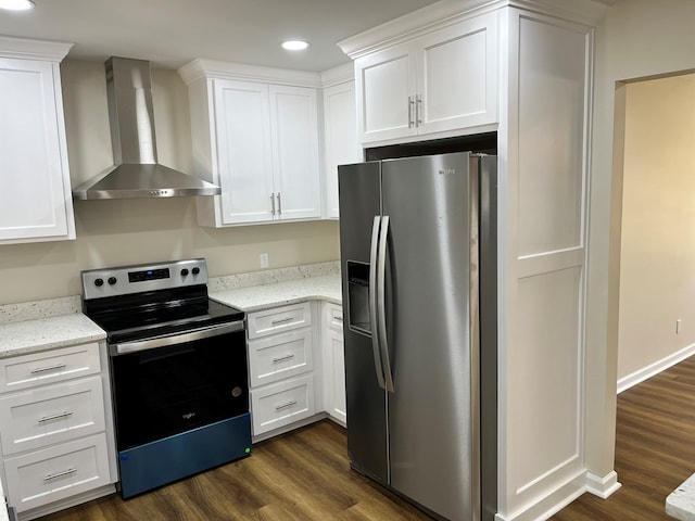 kitchen featuring wall chimney exhaust hood, white cabinetry, and appliances with stainless steel finishes