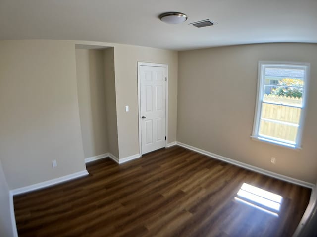 unfurnished room featuring dark hardwood / wood-style flooring